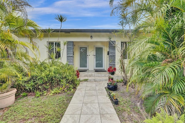 property entrance with stucco siding