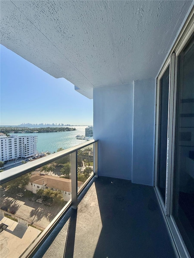 balcony with a water view and a city view