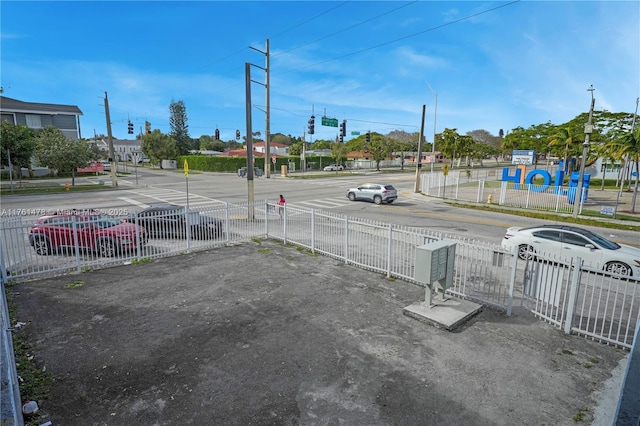 view of street featuring traffic lights and sidewalks