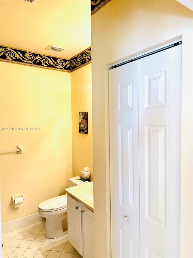 bathroom with visible vents, toilet, vanity, and tile patterned flooring