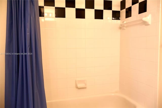 bathroom featuring shower / bathtub combination with curtain