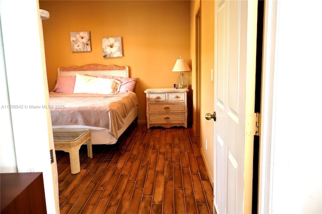 bedroom with dark wood finished floors