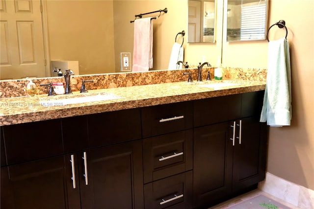 bathroom featuring double vanity and a sink