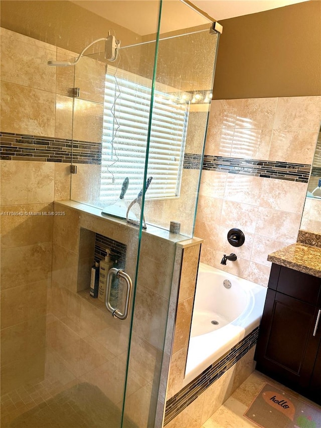 full bath featuring vanity, a shower stall, and a bath