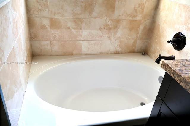 full bathroom with vanity and a bathtub