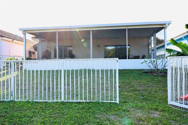 view of property exterior featuring central air condition unit, a yard, a sunroom, and stucco siding