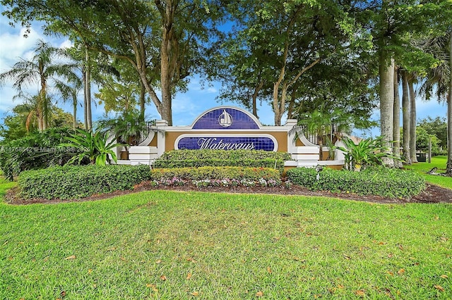 community / neighborhood sign with a yard