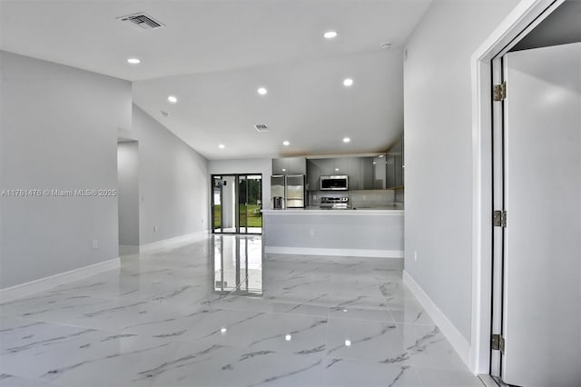 interior space featuring visible vents, modern cabinets, gray cabinetry, stainless steel appliances, and baseboards