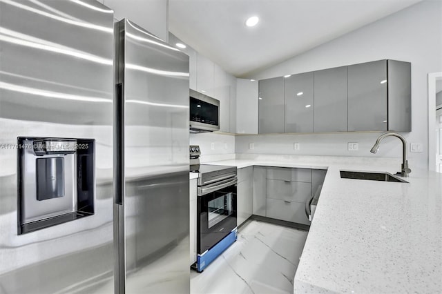 kitchen with gray cabinets, appliances with stainless steel finishes, modern cabinets, and a sink