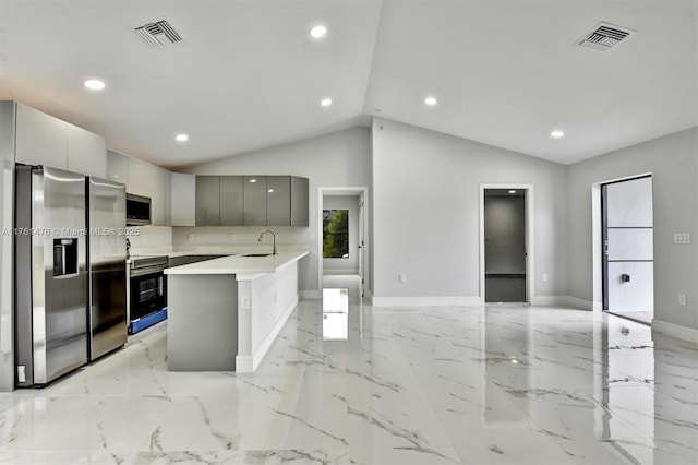 kitchen with visible vents, gray cabinets, a sink, stainless steel appliances, and modern cabinets