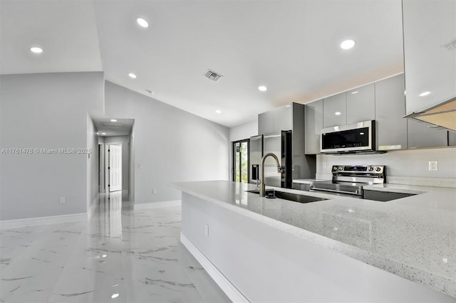 kitchen with visible vents, modern cabinets, gray cabinetry, a sink, and stainless steel appliances