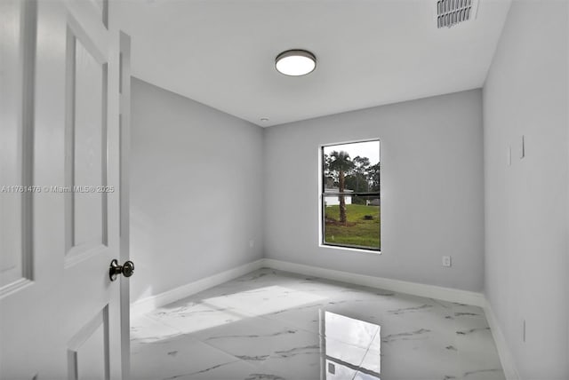 empty room featuring baseboards, visible vents, and marble finish floor