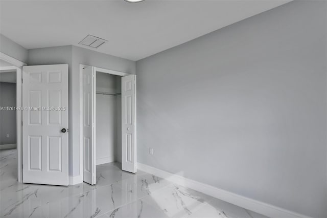 unfurnished bedroom with visible vents, baseboards, marble finish floor, and a closet