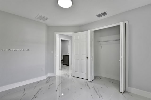 unfurnished bedroom featuring baseboards, visible vents, and marble finish floor