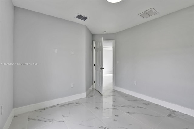 unfurnished room featuring visible vents, marble finish floor, and baseboards