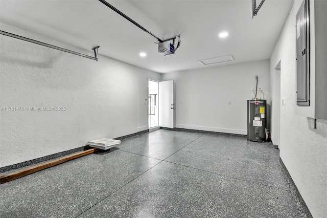 garage featuring baseboards, a textured wall, electric panel, electric water heater, and a garage door opener