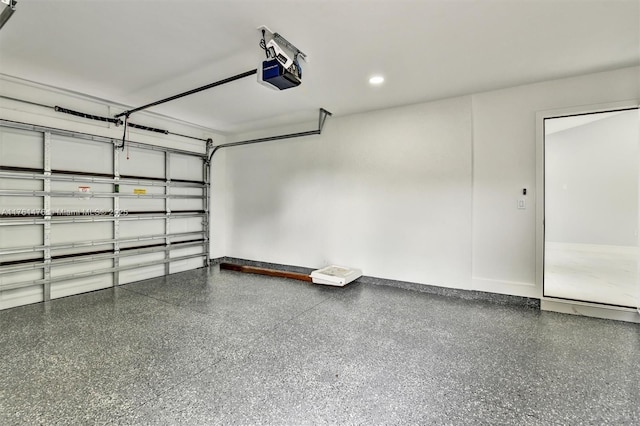 garage with recessed lighting and a garage door opener