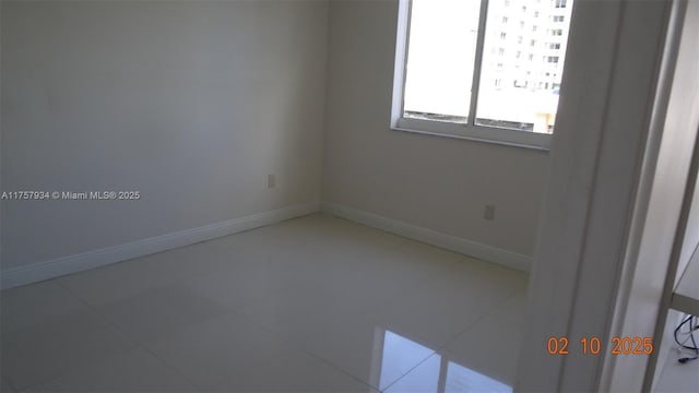 tiled spare room with baseboards