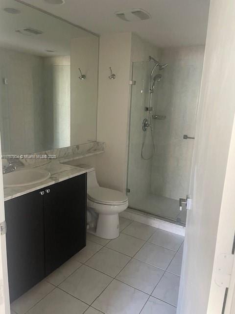 full bathroom with tile patterned floors, a stall shower, toilet, and vanity