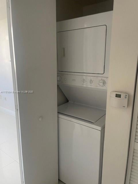 clothes washing area with laundry area and stacked washer / dryer