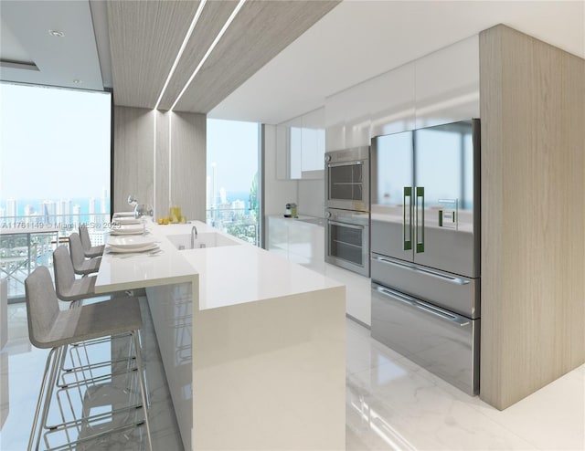 kitchen featuring modern cabinets, a view of city, appliances with stainless steel finishes, and white cabinets