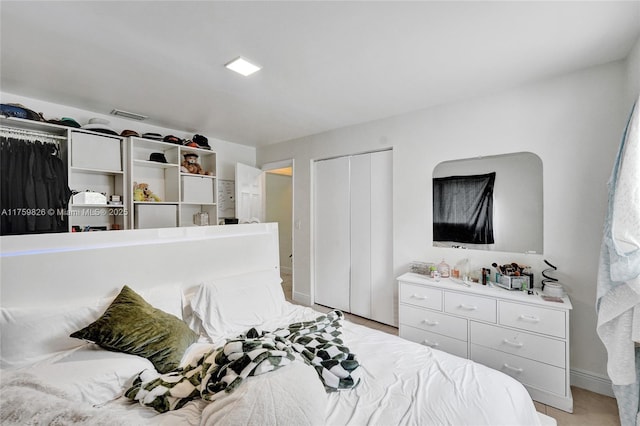 bedroom with a closet and baseboards