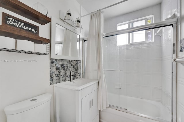 full bathroom with vanity, toilet, tasteful backsplash, and enclosed tub / shower combo