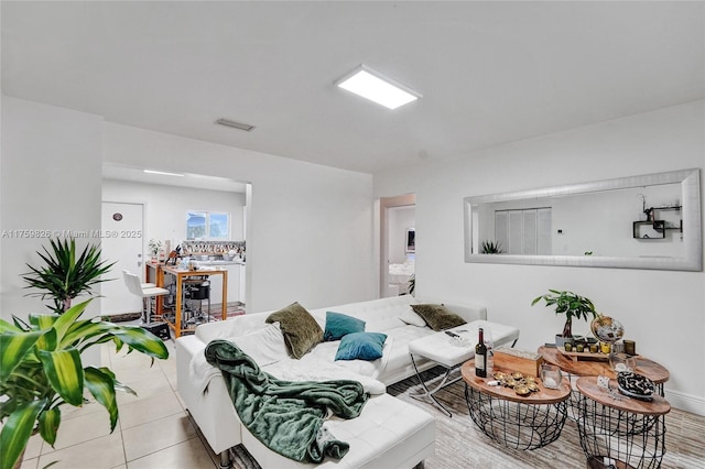 living area with tile patterned flooring and visible vents