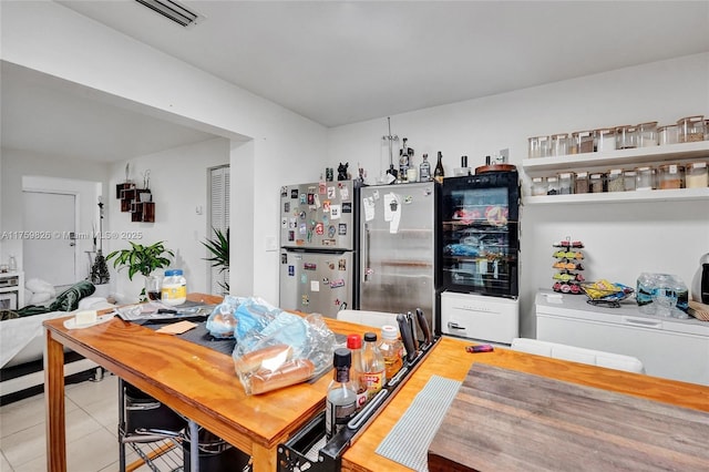 dining area featuring light tile patterned floors and visible vents