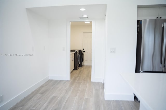 corridor featuring recessed lighting, visible vents, baseboards, and wood tiled floor