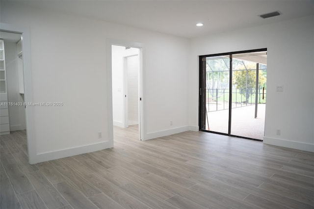 unfurnished room with visible vents, recessed lighting, baseboards, and light wood-style floors