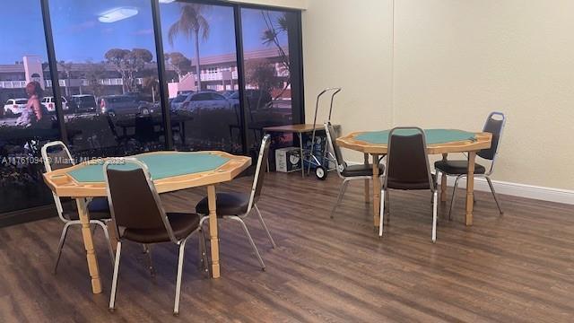 dining area with baseboards and wood finished floors