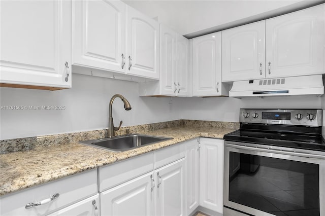 kitchen featuring ventilation hood, light stone counters, a sink, white cabinets, and electric stove