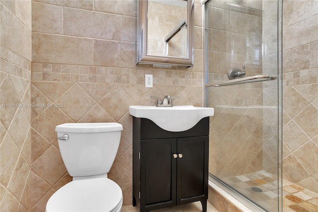 full bath with vanity, toilet, and a shower stall