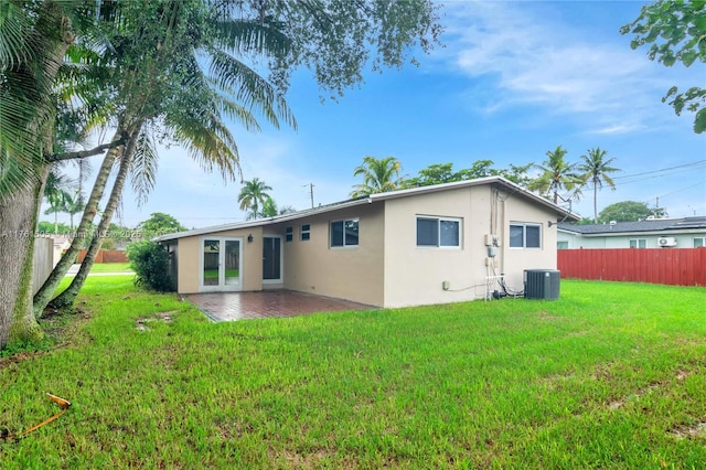 back of property with stucco siding, a lawn, a patio, fence, and cooling unit