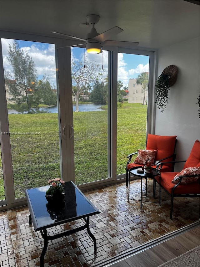 sunroom featuring plenty of natural light and a water view