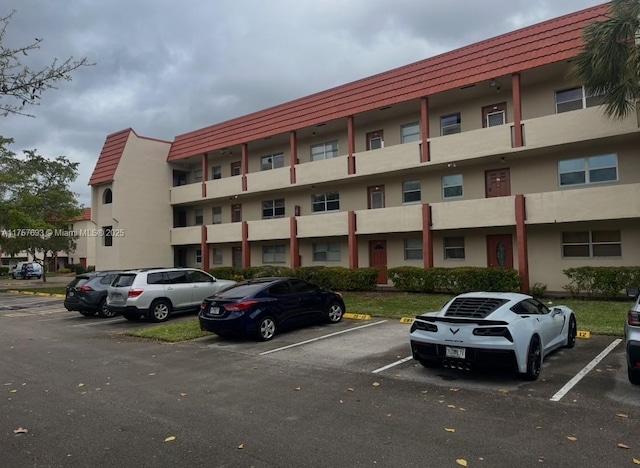 view of property featuring uncovered parking