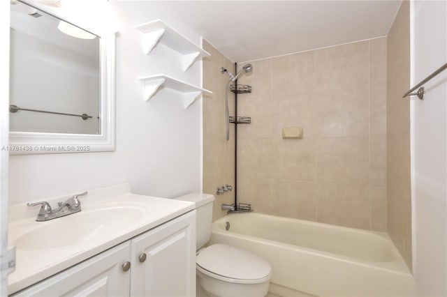 bathroom featuring toilet, vanity, and bathing tub / shower combination