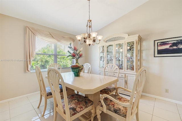 dining area featuring light tile patterned floors, an inviting chandelier, baseboards, and lofted ceiling