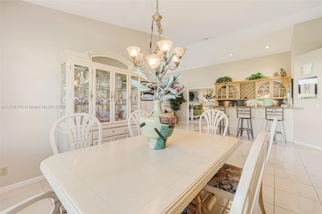 dining space featuring light tile patterned floors, a chandelier, recessed lighting, and baseboards