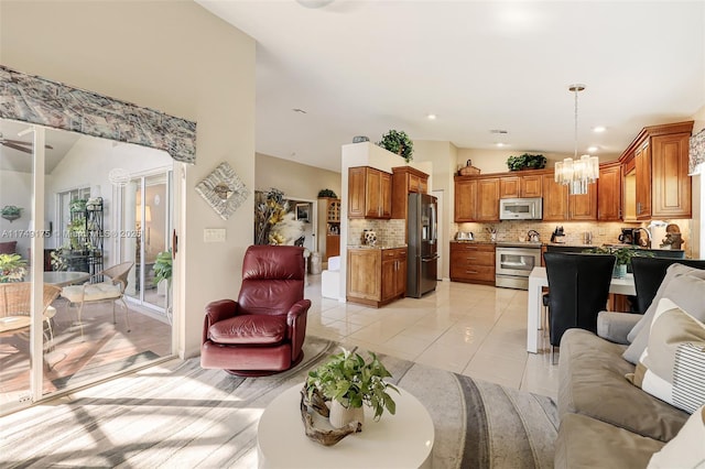 living room with recessed lighting, lofted ceiling, a notable chandelier, and light tile patterned flooring