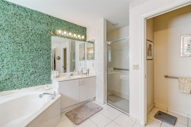 bathroom featuring a shower stall, tile patterned flooring, baseboards, a bath, and vanity