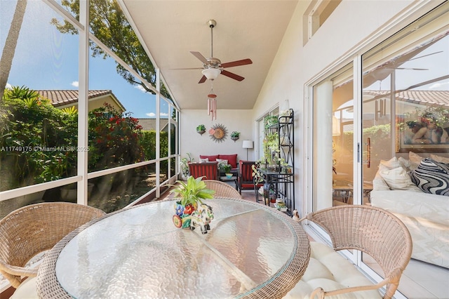 sunroom with a ceiling fan and vaulted ceiling