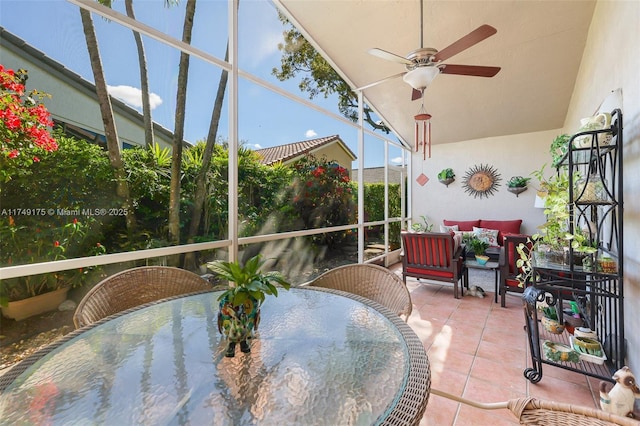 sunroom / solarium with lofted ceiling and a ceiling fan