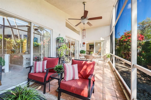 sunroom featuring ceiling fan