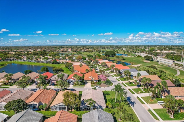 aerial view with view of golf course, a residential view, and a water view