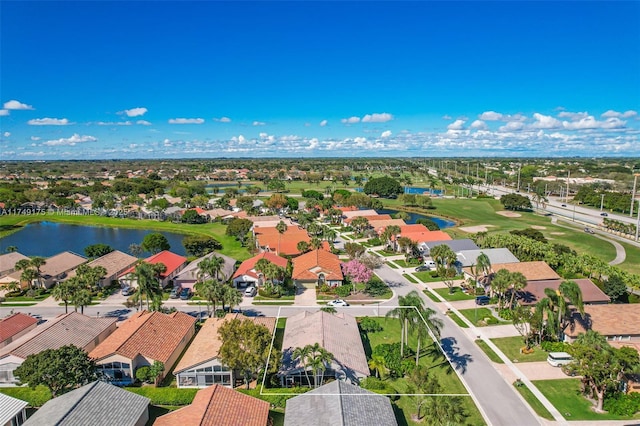 birds eye view of property featuring golf course view, a residential view, and a water view