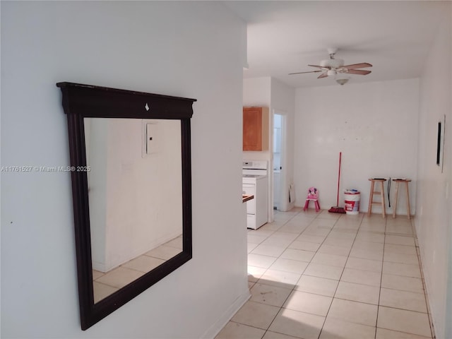 unfurnished room with light tile patterned floors and ceiling fan