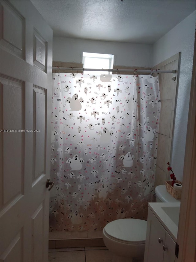 bathroom featuring tile patterned floors, a shower with curtain, toilet, and vanity