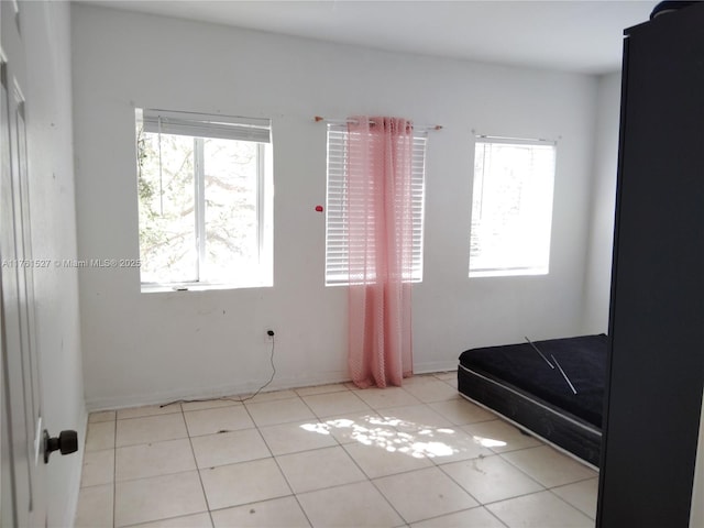 bedroom with light tile patterned floors